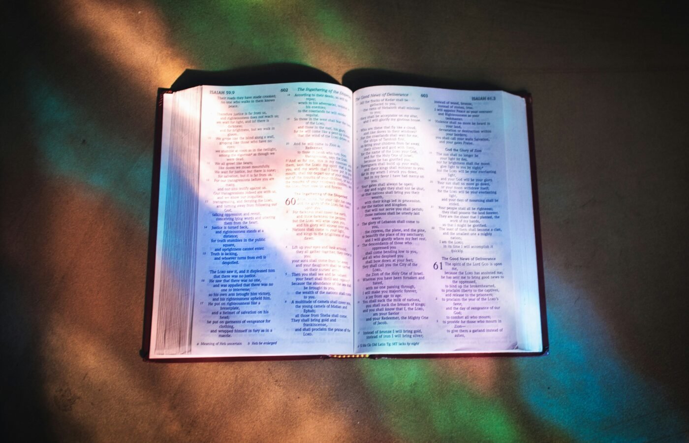 Open Bible on a table in sunlight — Photo by Shane Hoving on Unsplash