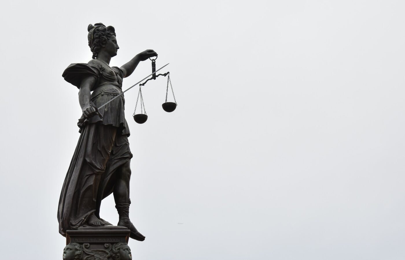 Lady Justice statue with scales — Photo by Gaétan Marceau Caron on Unsplash