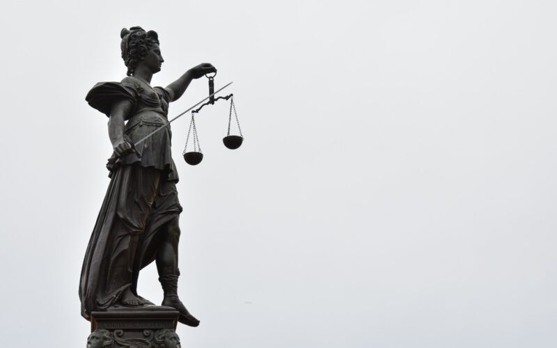 Lady Justice statue with scales — Photo by Gaétan Marceau Caron on Unsplash