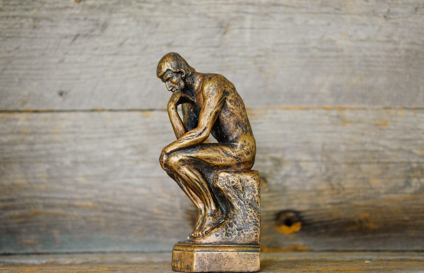 Bronze thinker statue — Photo by Ouilia on Unsplash