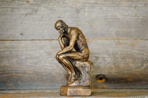 Bronze thinker statue — Photo by Ouilia on Unsplash