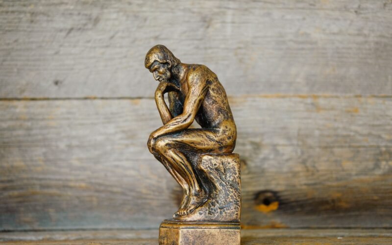 Bronze thinker statue — Photo by Ouilia on Unsplash